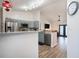 Open kitchen with stainless steel appliances and a view into the cozy living room at 1601 14Th W St, Palmetto, FL 34221