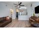 Inviting living room featuring wood floors, neutral paint and modern ceiling fan at 1601 14Th W St, Palmetto, FL 34221