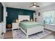 This main bedroom features a white bed frame and an accent wall painted in dark teal at 1601 14Th W St, Palmetto, FL 34221