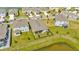 Aerial view of a fenced backyard, showcasing the home's proximity to a pond at 16633 Mooner Plank Cir, Wimauma, FL 33598