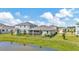 The serene backyard features a tranquil pond view and a comfortable screened patio at 16633 Mooner Plank Cir, Wimauma, FL 33598