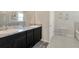 Stylish bathroom with dual sinks, granite countertops, and modern fixtures at 16633 Mooner Plank Cir, Wimauma, FL 33598