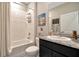Cozy bathroom features a shower-tub combo, sleek vanity with a marble countertop, and modern fixtures at 16633 Mooner Plank Cir, Wimauma, FL 33598