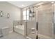 Luxurious bathroom with glass-enclosed shower, soaking tub, and elegant tile work at 16633 Mooner Plank Cir, Wimauma, FL 33598