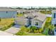 Inviting single-story home with lush landscaping and a picturesque pond view in a desirable neighborhood at 16633 Mooner Plank Cir, Wimauma, FL 33598