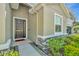 A welcoming entryway showcasing a modern front door and manicured garden at 16633 Mooner Plank Cir, Wimauma, FL 33598