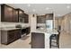 Kitchen boasts granite counters, stainless appliances, and center island with seating at 16633 Mooner Plank Cir, Wimauma, FL 33598