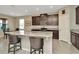 Open concept kitchen with stainless appliances, granite counters, and breakfast bar seating at 16633 Mooner Plank Cir, Wimauma, FL 33598