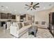 Inviting living room with stylish sofas, sleek coffee table, and an open layout connected to the kitchen at 16633 Mooner Plank Cir, Wimauma, FL 33598