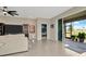 Spacious living room with a view of the outdoor patio through sliding glass doors at 16633 Mooner Plank Cir, Wimauma, FL 33598
