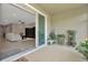 Covered patio featuring plants and sliding glass doors leading into a living area at 16633 Mooner Plank Cir, Wimauma, FL 33598