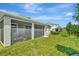 A screened patio is attached to the home with a lush green backyard at 16633 Mooner Plank Cir, Wimauma, FL 33598