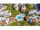 Aerial view of condo complex with a swimming pool and neatly manicured lawns at 2205 Belleair Rd # A24, Clearwater, FL 33764