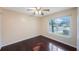 Cozy bedroom with a ceiling fan and large window allowing for ample natural light at 2205 Belleair Rd # A24, Clearwater, FL 33764