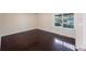 Comfortable bedroom featuring hardwood floors, a window, and neutral wall, ideal for relaxation and rest at 2205 Belleair Rd # A24, Clearwater, FL 33764