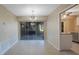 Bright dining area with tile flooring, elegant light fixture, and sliding door access to a private outdoor space at 2205 Belleair Rd # A24, Clearwater, FL 33764