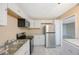 Updated kitchen with stainless steel refrigerator and modern appliances at 2205 Belleair Rd # A24, Clearwater, FL 33764