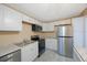 Bright kitchen featuring stainless steel appliances, marble countertops, and crisp white cabinets at 2205 Belleair Rd # A24, Clearwater, FL 33764