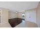 Spacious living room with hardwood floors, tile transition, a ceiling fan, and ample closet space at 2205 Belleair Rd # A24, Clearwater, FL 33764