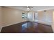 Bright living room showcasing dark hardwood floors, a ceiling fan, and ample natural light at 2205 Belleair Rd # A24, Clearwater, FL 33764