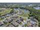 Birds eye view of a neighborhood nestled near lush greenery, bodies of water, and a local baseball field at 2310 Wood Pointe Dr, Holiday, FL 34691