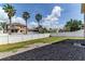Spacious backyard featuring a white vinyl fence, green grass, and a rock area at 2310 Wood Pointe Dr, Holiday, FL 34691