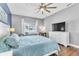 Bedroom features hardwood flooring, ceiling fan, and natural light at 2310 Wood Pointe Dr, Holiday, FL 34691