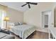 Bedroom with wood floor, ceiling fan, and open doorway at 2310 Wood Pointe Dr, Holiday, FL 34691