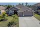 Well-maintained single Gathering home featuring a spacious driveway and a beautiful lawn at 2310 Wood Pointe Dr, Holiday, FL 34691