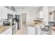 Modern kitchen featuring white cabinets, granite counters, and a breakfast bar with seating at 2310 Wood Pointe Dr, Holiday, FL 34691