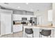 Spacious kitchen with white cabinets, stainless steel appliances, and a breakfast bar at 2310 Wood Pointe Dr, Holiday, FL 34691