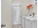 Bright laundry room with white washer, dryer, storage shelf, and door access at 2310 Wood Pointe Dr, Holiday, FL 34691