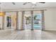 Open living room features three sliding doors which lead to views of a swimming pool at 2310 Wood Pointe Dr, Holiday, FL 34691