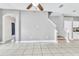 The living room features tile floors, neutral paint, and stairway to the second floor at 2310 Wood Pointe Dr, Holiday, FL 34691