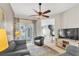 Cozy living room featuring a ceiling fan, neutral paint, and sliding glass doors to the pool at 2310 Wood Pointe Dr, Holiday, FL 34691