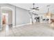 Open-concept living area offers a staircase, kitchen view, and light tiled flooring at 2310 Wood Pointe Dr, Holiday, FL 34691