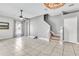 Bright, open living room features tile flooring, ceiling fan, and stairway access to the home's second level at 2310 Wood Pointe Dr, Holiday, FL 34691