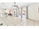 Open living space with tile floors and views of the outdoor pool area through sliding doors at 2310 Wood Pointe Dr, Holiday, FL 34691