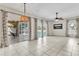 Expansive living room with tiled flooring and sliding glass doors opening to the lanai and pool at 2310 Wood Pointe Dr, Holiday, FL 34691
