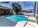 Beautiful screened-in pool with a spacious deck, great for outdoor entertaining and lounging at 2310 Wood Pointe Dr, Holiday, FL 34691