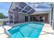 Inviting screened-in pool area, perfect for relaxation and fun in the sun at 2310 Wood Pointe Dr, Holiday, FL 34691