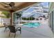 Inviting screened-in pool area with comfortable seating, perfect for outdoor relaxation and entertainment at 2310 Wood Pointe Dr, Holiday, FL 34691