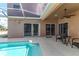 Relaxing screened-in pool area with cozy seating and seamless indoor-outdoor living at 2310 Wood Pointe Dr, Holiday, FL 34691