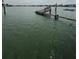 Picturesque waterfront scene of damaged wooden dock extending into the water at 249 144Th Ave, Madeira Beach, FL 33708