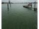 Picturesque waterfront scene of damaged wooden dock extending into the water at 249 144Th Ave, Madeira Beach, FL 33708
