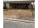 Modest single-story home with gravel yard and covered parking showing front entrance at 249 144Th Ave, Madeira Beach, FL 33708
