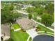 Aerial view of a beautiful home with a landscaped yard, mature trees, and a nearby neighborhood at 30623 Bittsbury Ct, Wesley Chapel, FL 33543