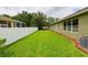 A green, manicured lawn and neutral-colored exterior, complemented by lush landscaping, creates a serene outdoor space at 30623 Bittsbury Ct, Wesley Chapel, FL 33543