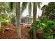 A partial view of the backyard showcases the screened-in pool and beautifully landscaped yard at 30623 Bittsbury Ct, Wesley Chapel, FL 33543