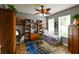 Cozy bedroom featuring wood floors, built-in shelving, and a ceiling fan at 30623 Bittsbury Ct, Wesley Chapel, FL 33543